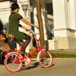 Girl on a red second-hand bike